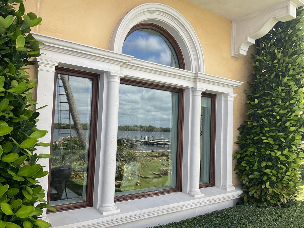 Arched estate window with limestone trim, lakeside Palm Beach residence