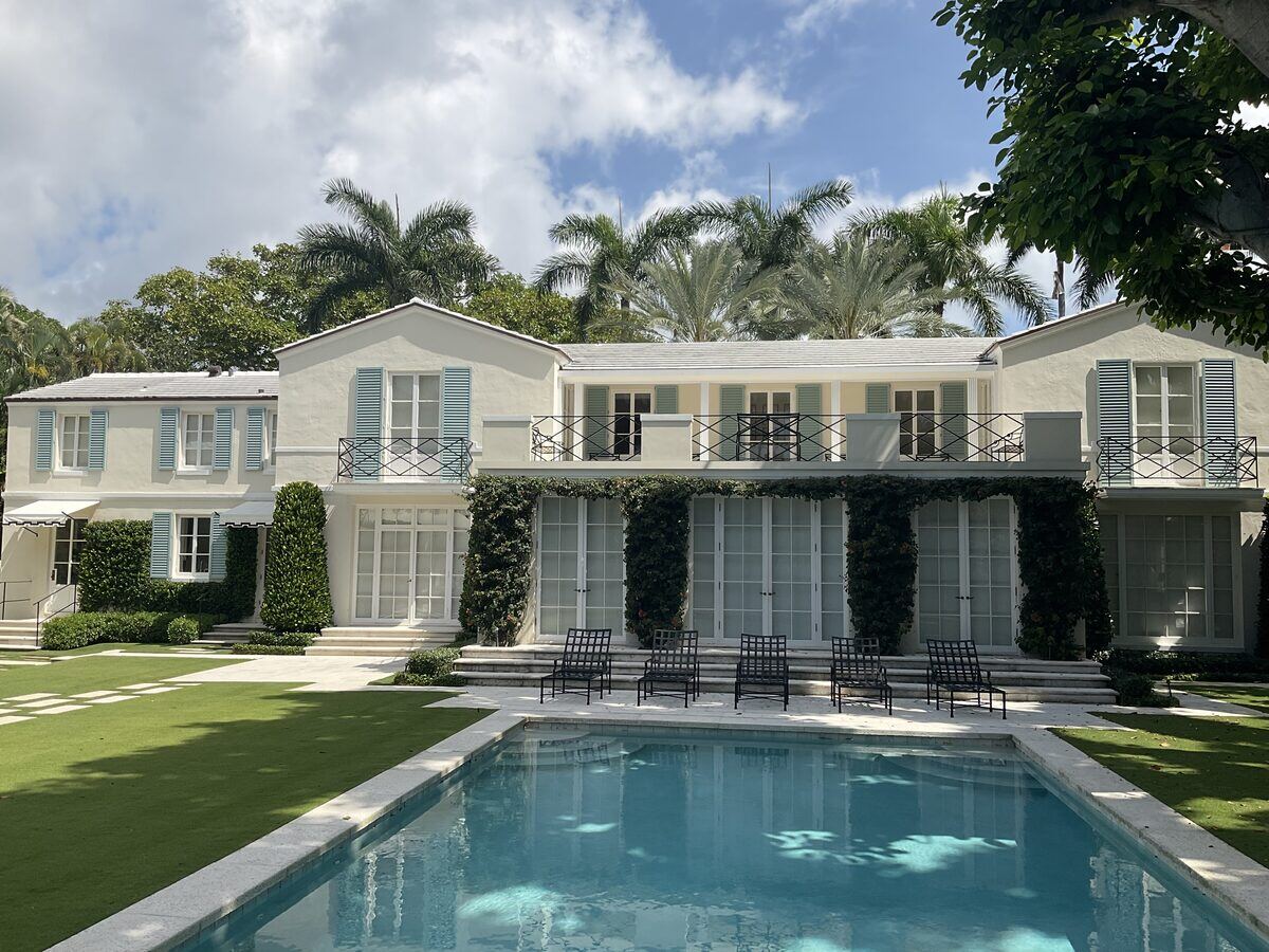 Two-story estate with palms and pool