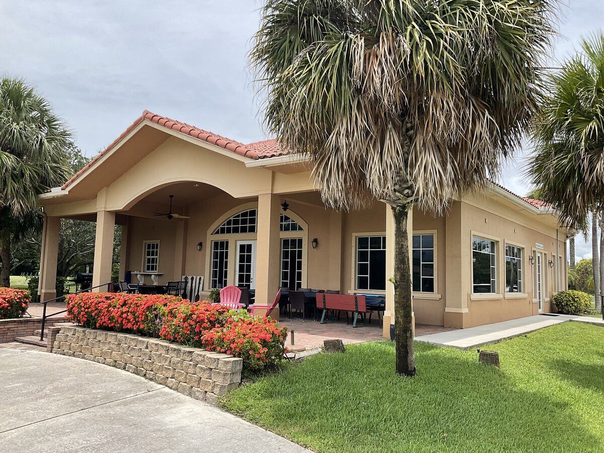 Peach stucco residence with arched portico entry