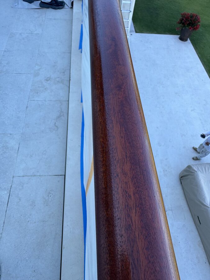 Glossy refinished wood handrail detail