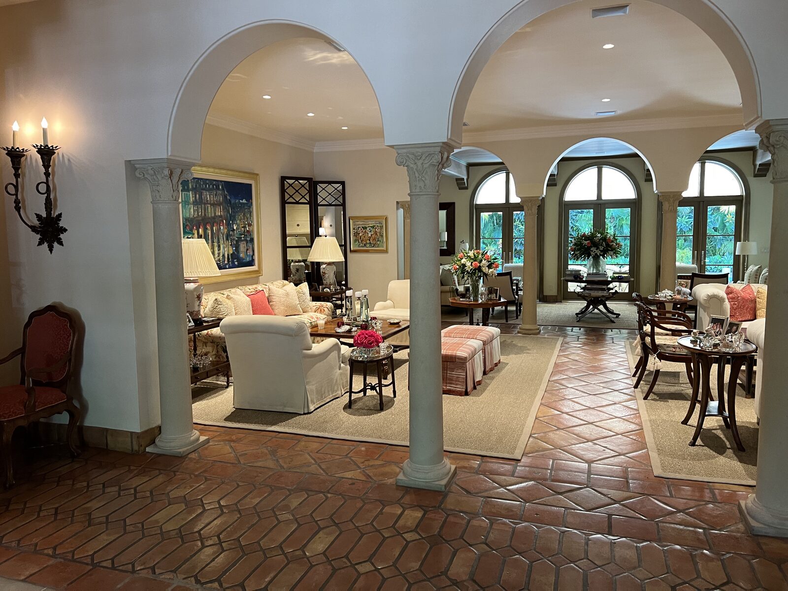 Arched colonnade living room with hand-finished plaster walls and terracotta floor