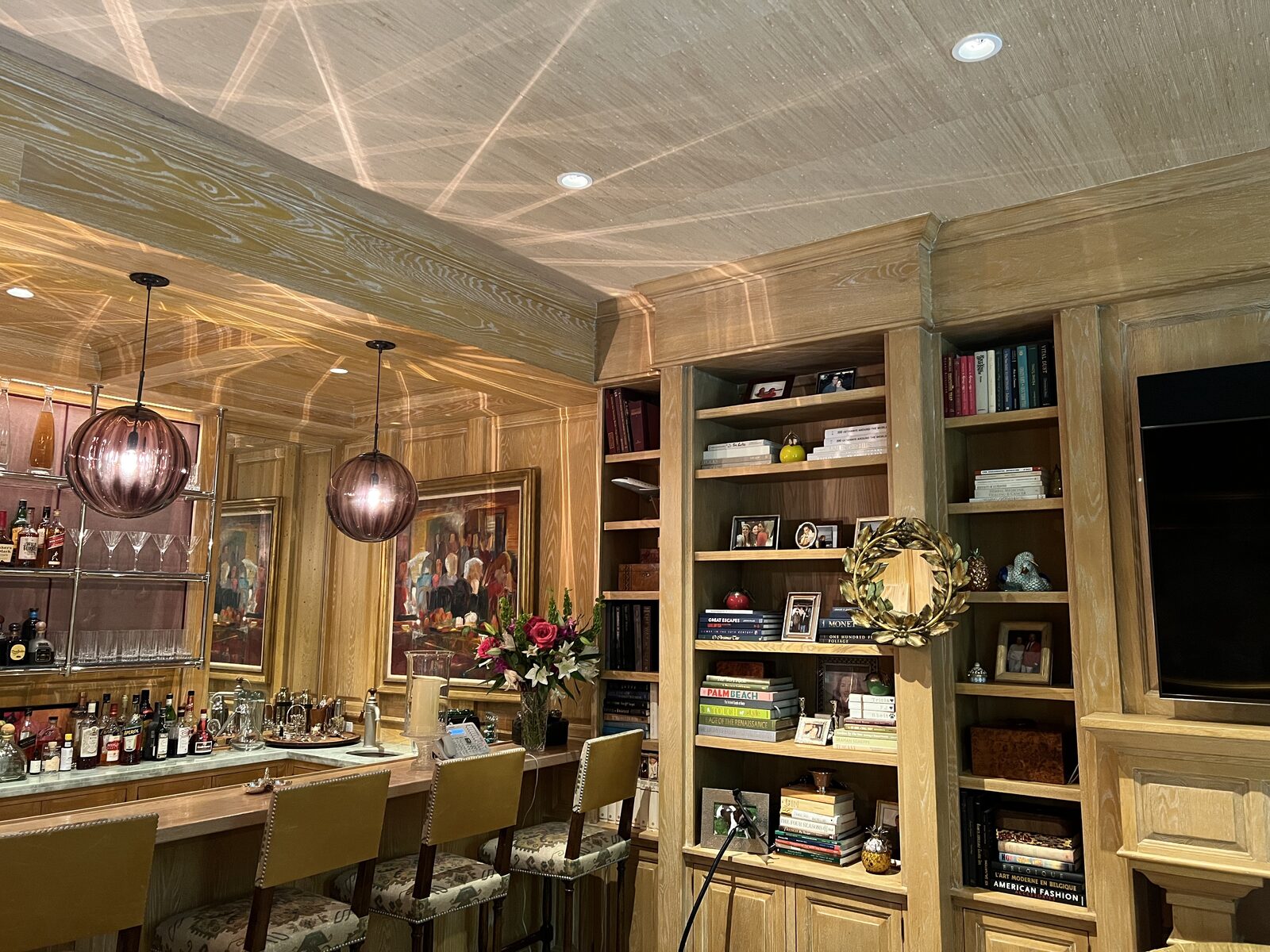 Cerused oak wet bar with blown-glass pendants and backlit glass shelving