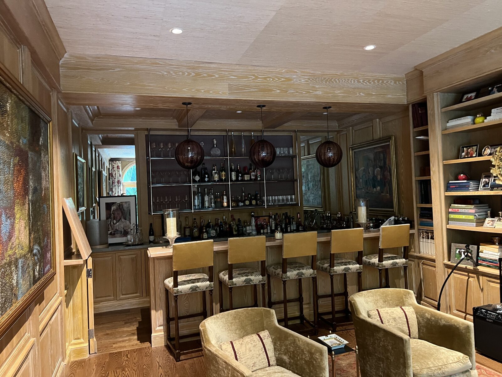 Cerused oak bar room with limed paneling and coffered wood ceiling