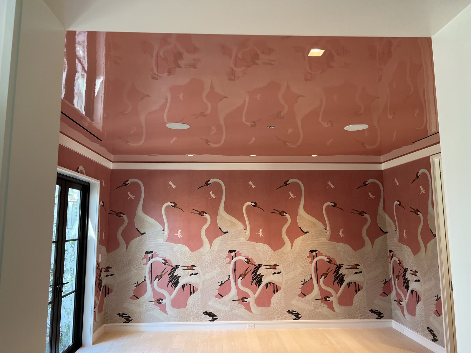 Crane mural room with high-gloss rose lacquered ceiling and white trim