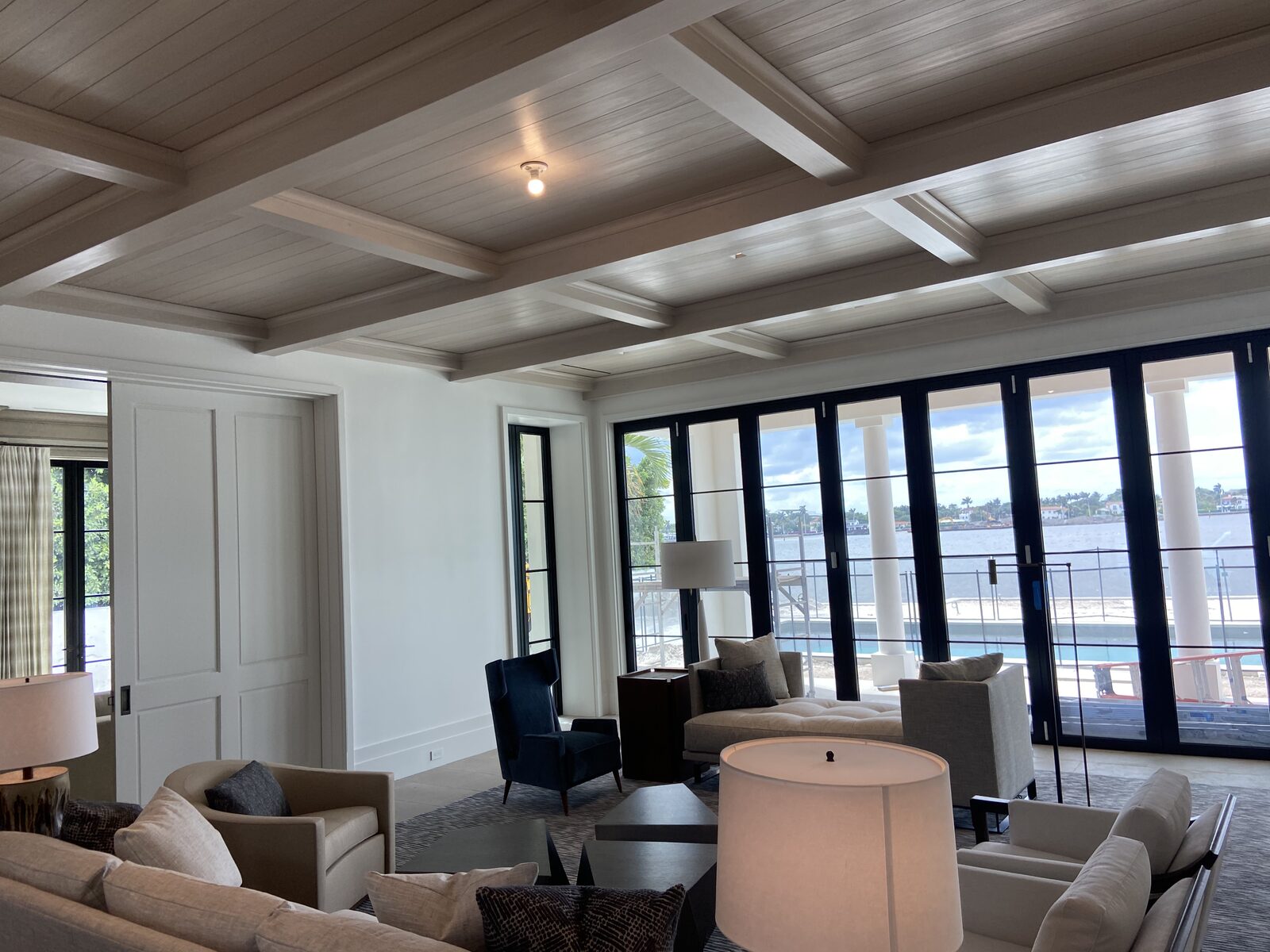 Waterfront living room with cerused coffered plank ceiling